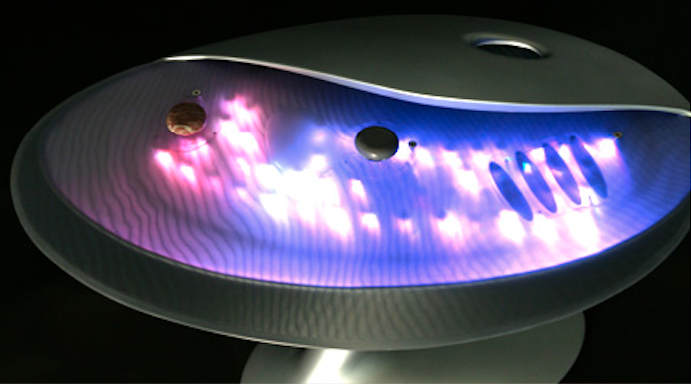 The concept included sound, light, and a unique user interface, including capacitive gesture recognition. “Magical Stones” placed on the surface triggered different moods by varying their position and orientation.